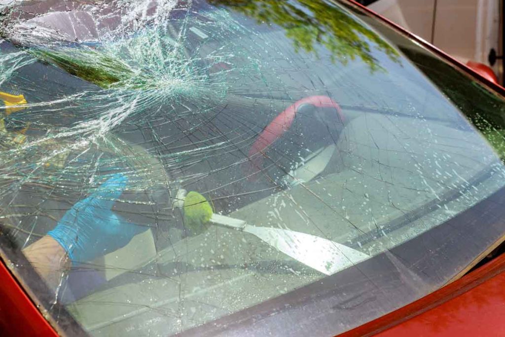 Removing a damaged windshield from a car